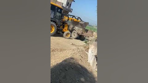 Jcb loading soil in tractor