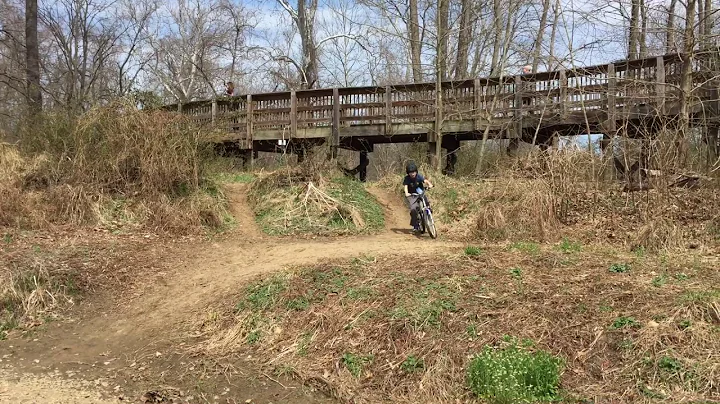 Kid rides down dirt hill onto rocks