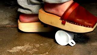 Crushing a coffee cup with thick wooden clogs