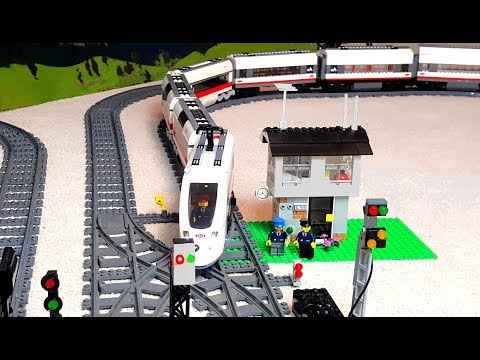 Long train arriving and leaving Lego City railway station. 
