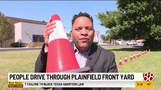 Motorists drive through Plainfield, Indiana, front yard