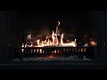 Burning Fireplace with slow crackling Fire.  Wooden log surrounded by orange and blue flames