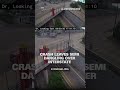 Crash leaves semi dangling from overpass