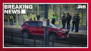Car drives onto light rail tracks in Seattle