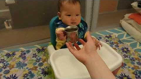 Poohbei drank water from an open cup - 11-month-old baby