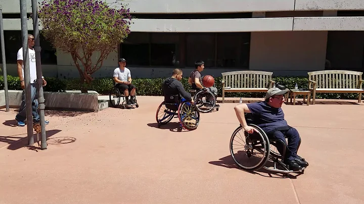 Our Founder Troy Plunkett leading 2 wheelchair bas...