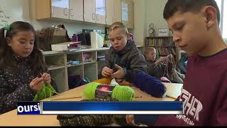 Fifth-graders knit scarves for the homeless