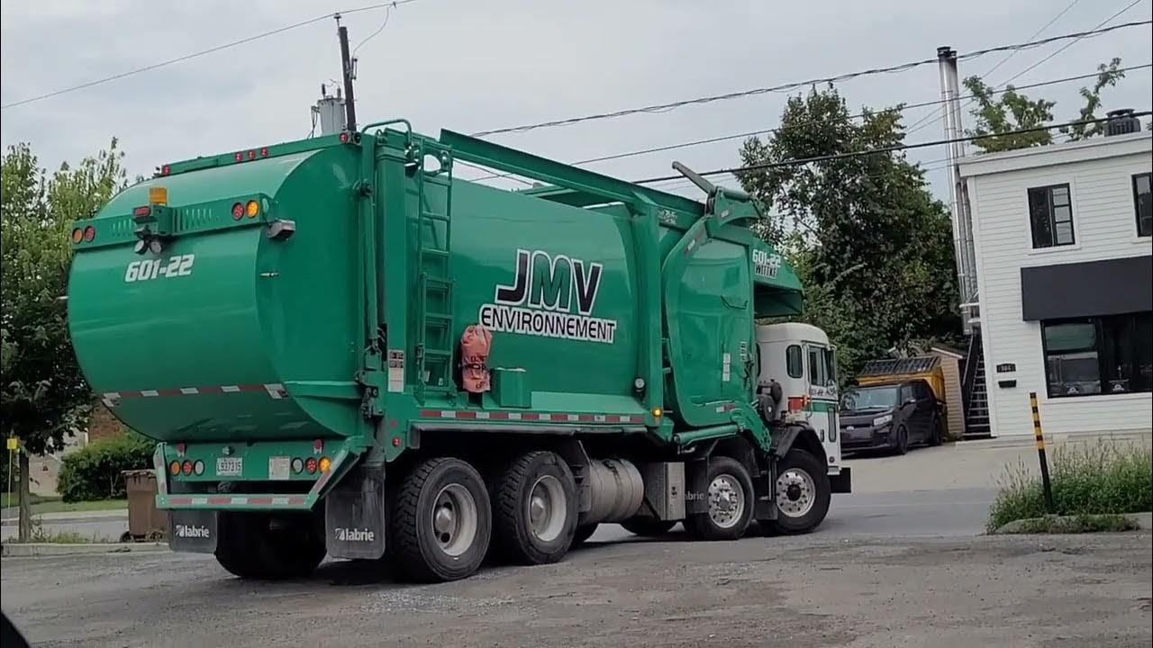 Several Different Types Of JMV Environnement Garbage Trucks On The Road