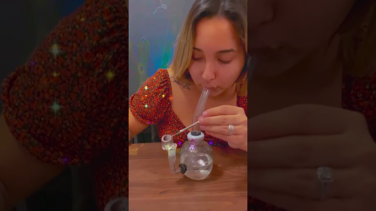 Enjoying her upcycled apple juice glass made into a bong