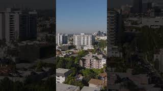 Aerial shot of various buildings in large city on sunny day. Multistorey luxury hotels. Los Angeles