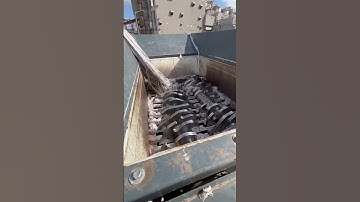 Sennebogen 718 feeding M&J Shredder strips of Polyester