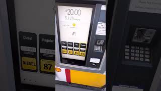 Pumping gas in gas station/shell