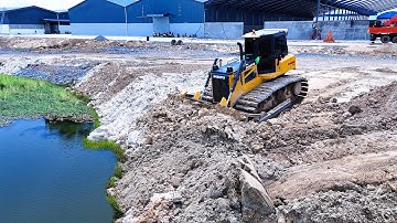 Awesome skill bulldozer operator pushing soil filling with huge bulldozer