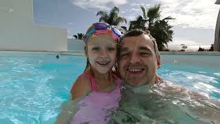 Daddy and daughter in swimming pool