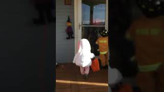 Little girl wearing bunny rabbit costume gets hit by door on her first time trick-or-treating