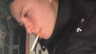 The girl smokes a cigarette secretly in her own home, spits and litters.