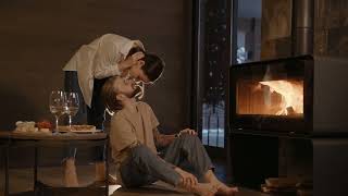 Coupe Kissing in Front of a Fireplace