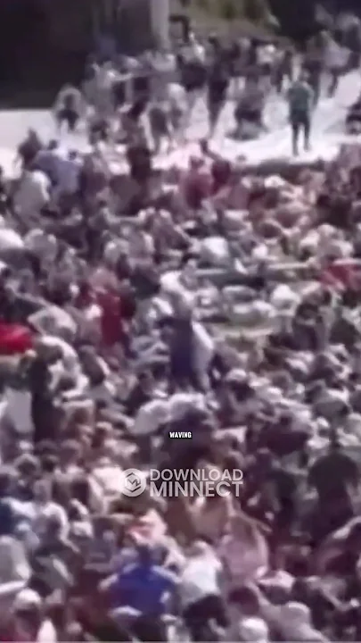WATCH as George Zinn in the Crowd Appears to Set Something Down