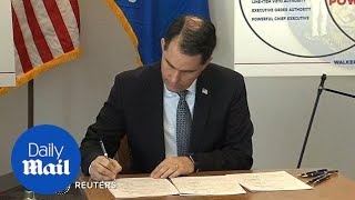 Republican Governor, Scott Walker, signs power grab bills