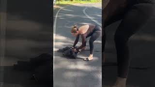 Lady Saves and Reallocates a Lizard Away from the Road