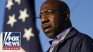 Raphael Warnock holds a drive-in rally