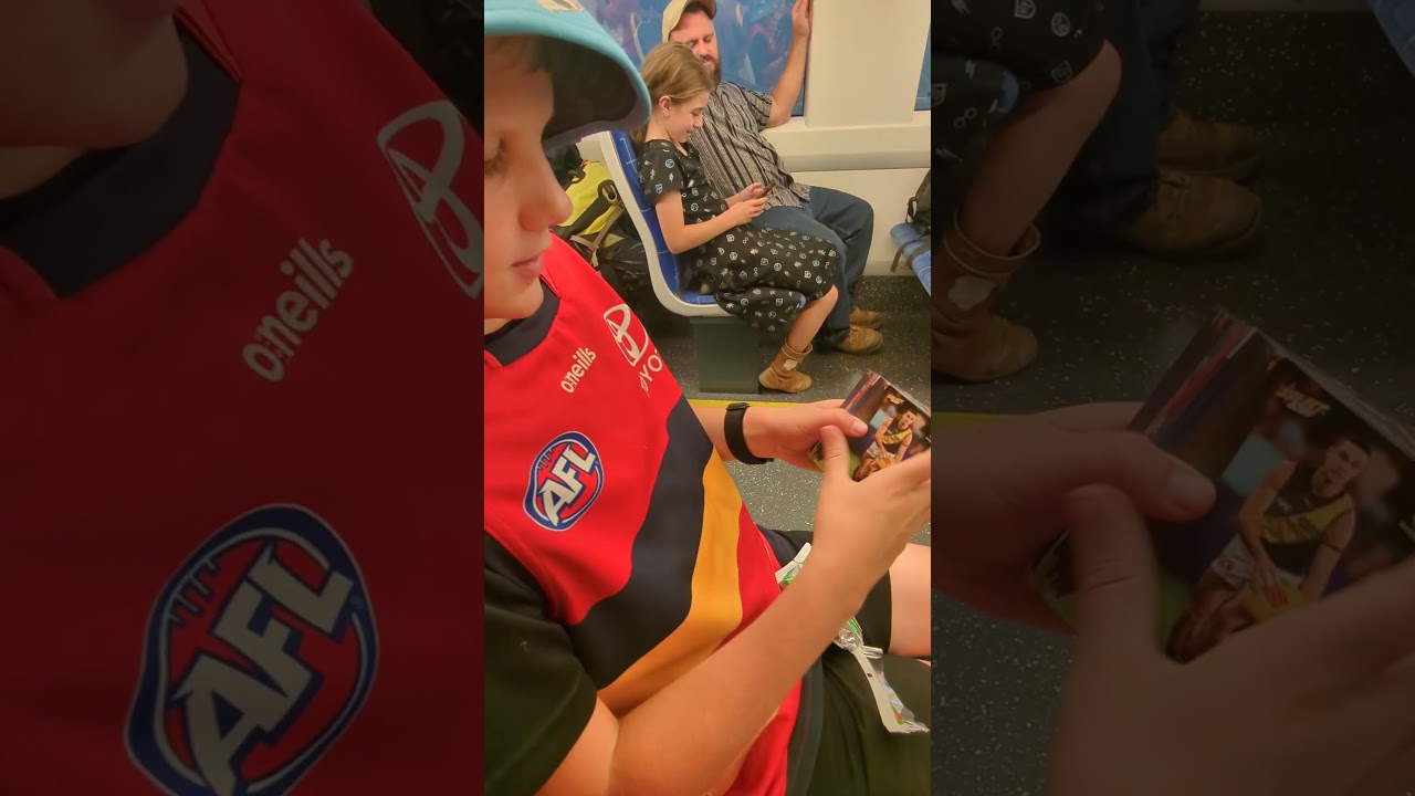 Opening a hobby pack of Select AFL footystars footy cards on the train home after a big crows win!