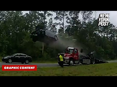 Speeding car flies through the air after launching off tow truck ramp on highway in wild video