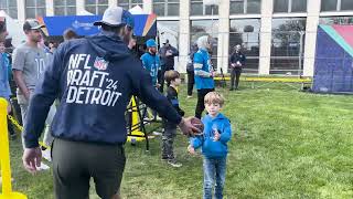 Fans pack downtown Detroit, toss footballs at NFL Draft