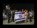 Crowd cheers released Israeli hostages as they are driven to military air base