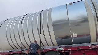 Loading a 30-ton plastic storage tank to ship.