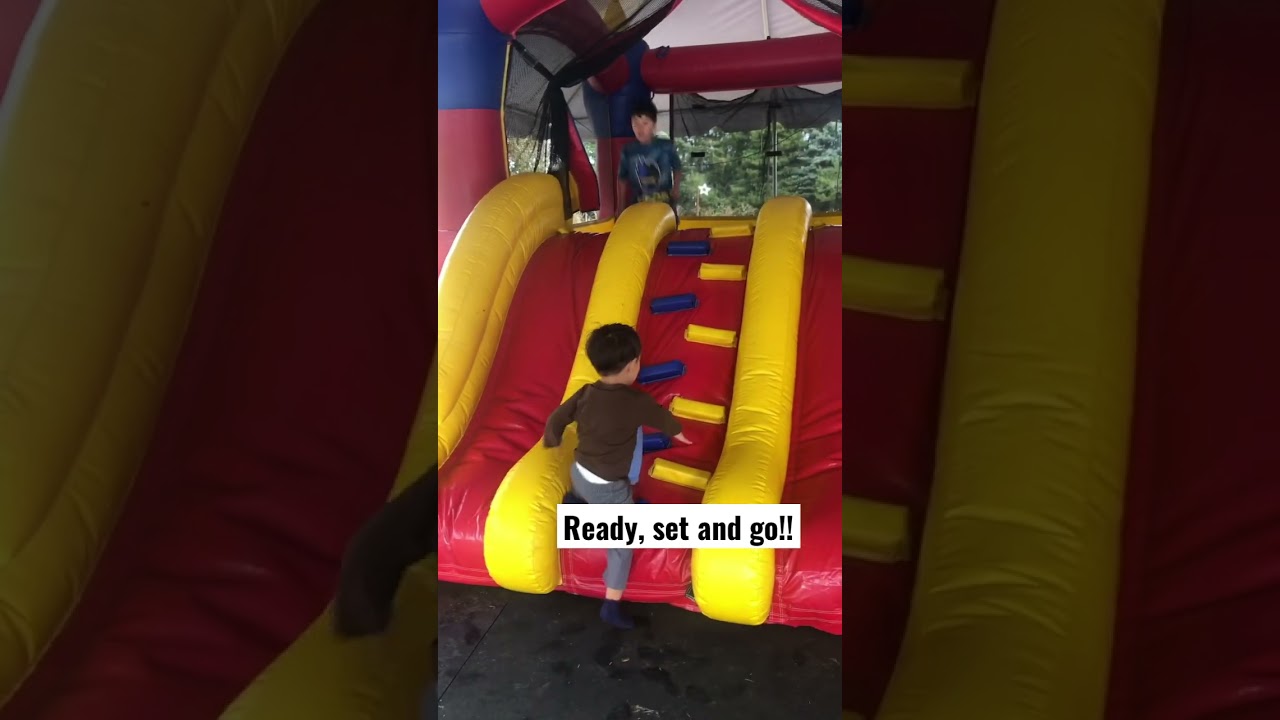 Boys having fun on this cool bouncy slides. 