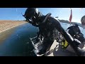 Frogman in rubber diving suit doing a giant stride off the dive boat to go for a dive