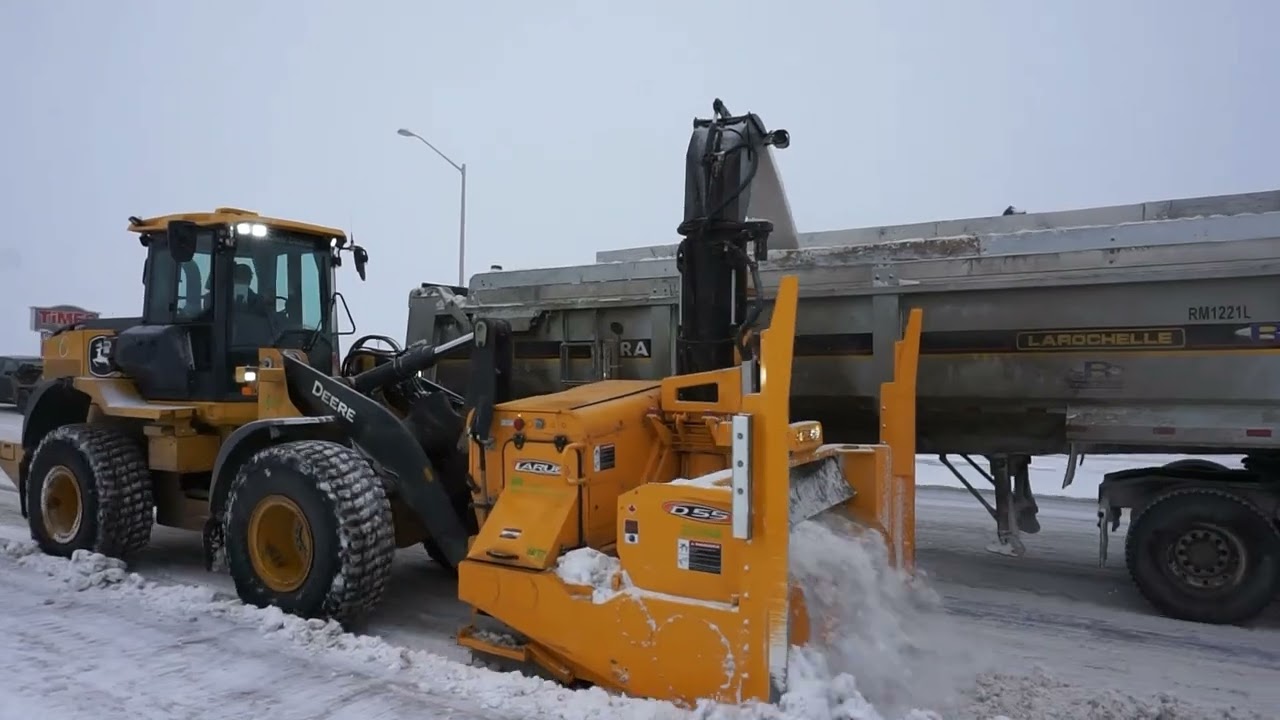 Larue D55 loader-mounted snow blower loading trucks and side casting