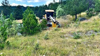 How did the John Deere grader achieve the slopes