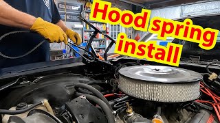 New hood springs and hinges are installed on the 80 Chevy Camaro