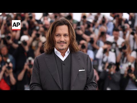 Johnny Depp tries to keep focus on film in Cannes