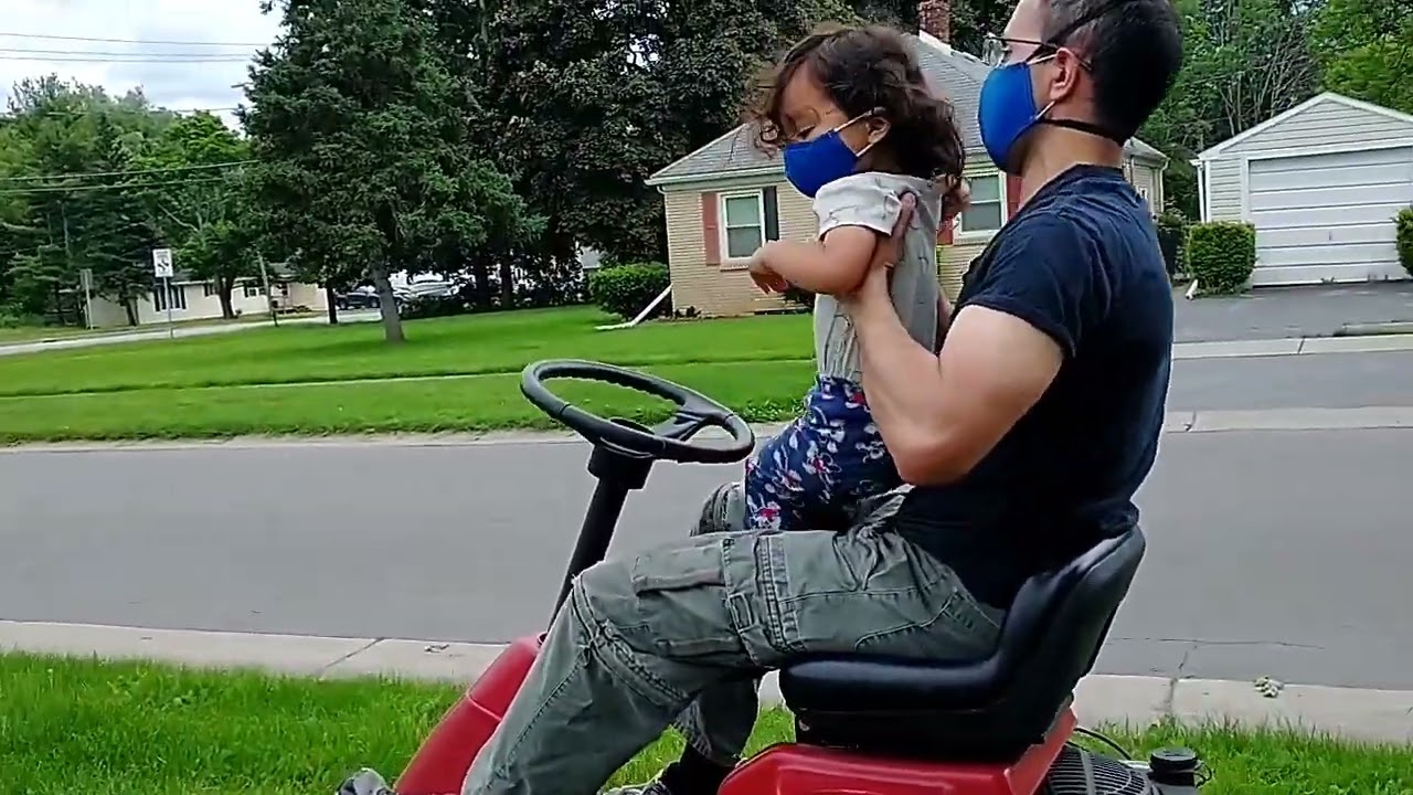 Look.. who is enjoying the lawn mower ride with his papa?
