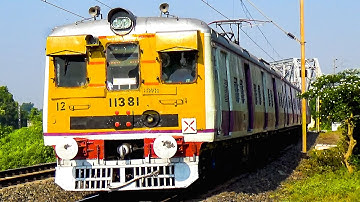 EMU Local train made a aggressive curvy entrance through a curve under a beautiful rail bridge
