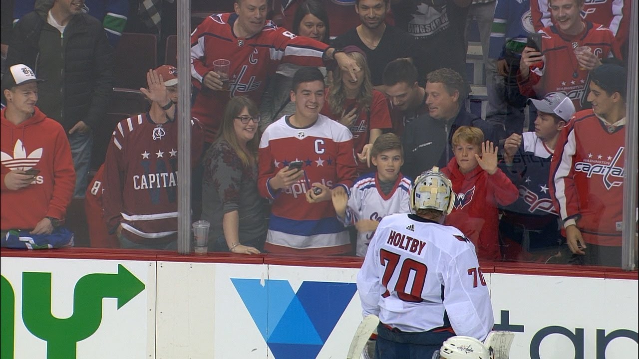 Holtby not amused as adult fan takes puck away from younger Capitals fan