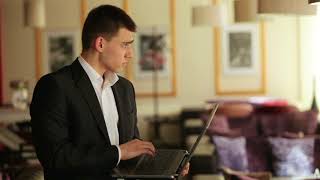 Businessman Standing In A Cafe With A Laptop 4Kpq0Aqrg  D