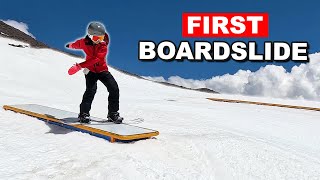 Teaching Snowboarder Her First Boardslide on a Box