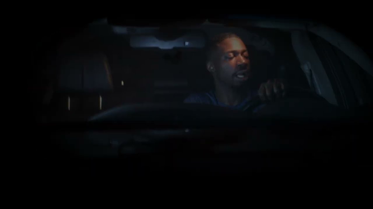 Still from the No Where To Run visualizer: NovA alone at the wheel of a car at night
