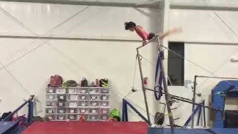 Girl Gymnast Performs Double Back Dismount on Uneven Bars - 1025618-6