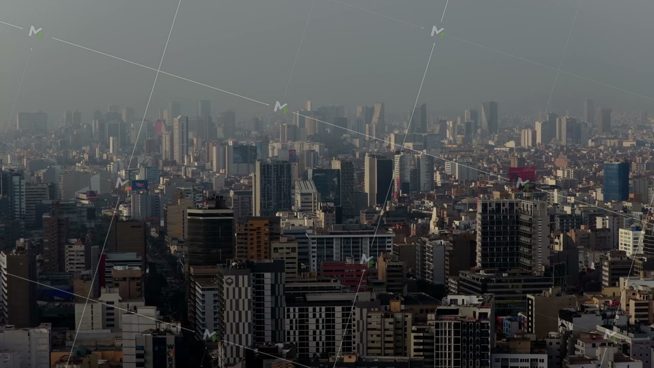 Vast urban sprawl of Lima, Peru, with dense downtown district under a hazy and polluted sky. Aerial