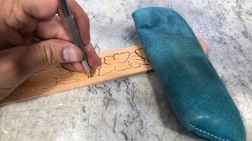 Tooling a belt pattern with flowers and leaves from my tooling pattern book