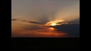 Annular Solar Eclipse appearing out of the clouds at Sunset