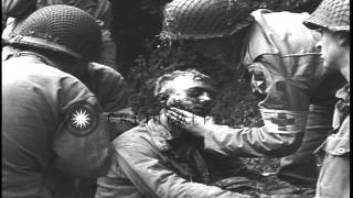 US medics treating and bandaging a wounded soldier in France. HD Stock Footage