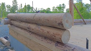 stacking the log walls for cabin