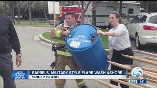 Barrels, military-style flare wash ashore