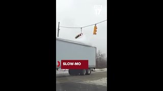 Mound of snow on semi trailer takes out traffic signal